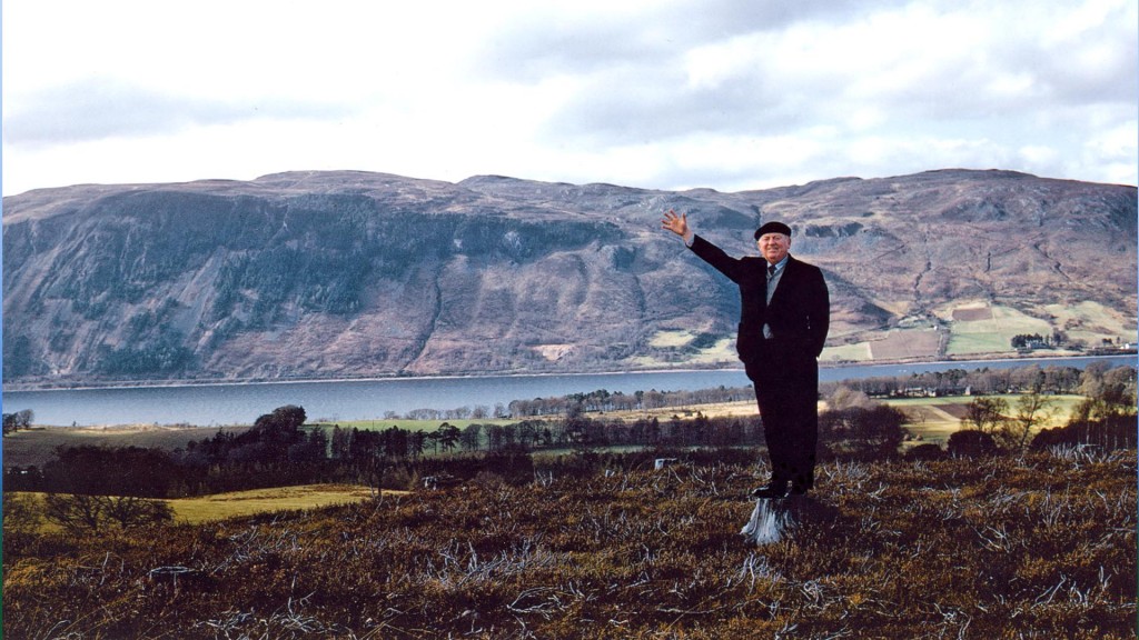 Hughston McBain 21st chief of Clan McBain circa 1961. Standing on the memorial spot of the park with the town of Dores and Loch Ness in the backgrond.